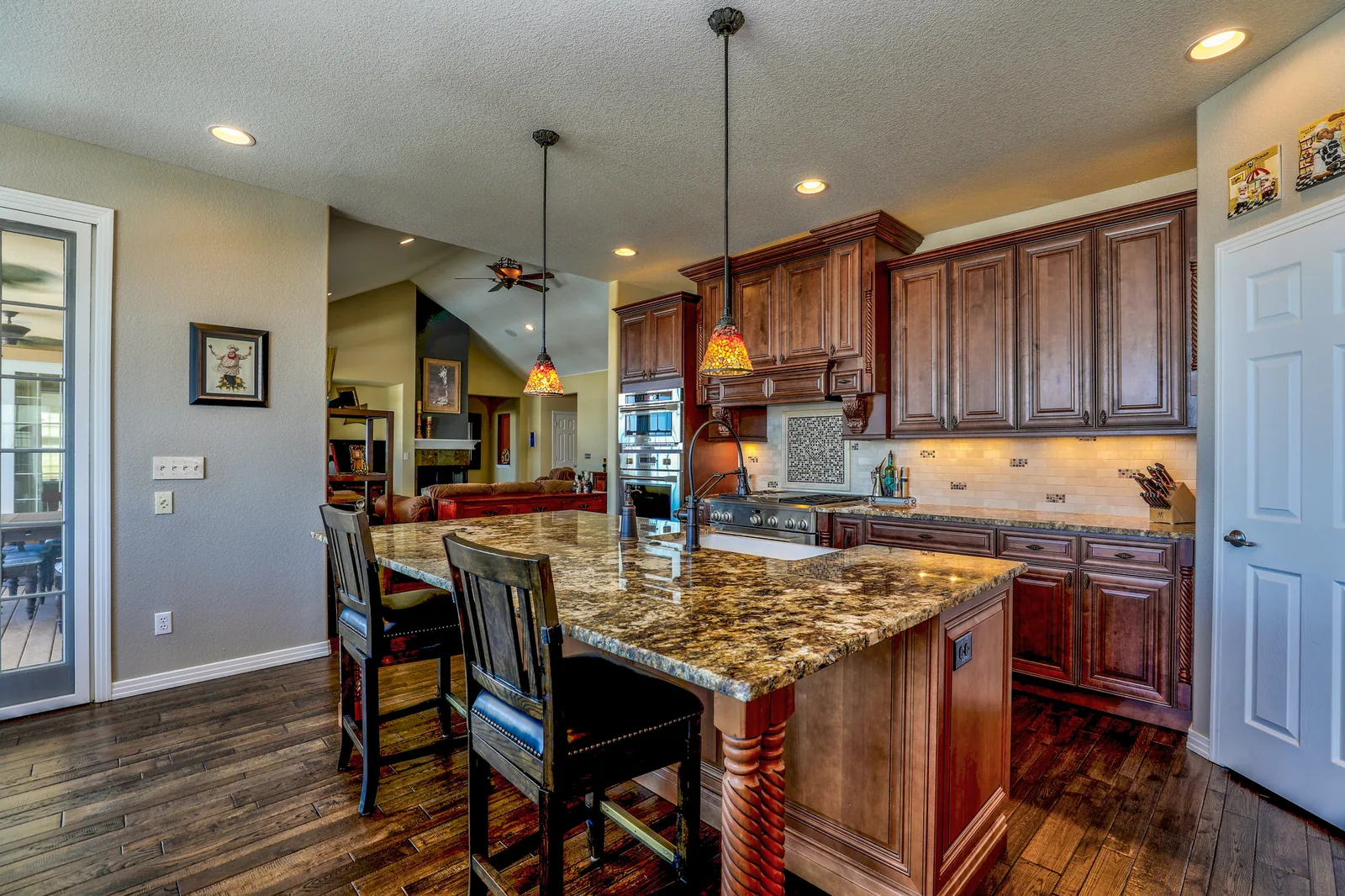 Before: dark wooden cabinetry and granite counters in a closed layout